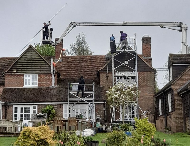 The Moss Cleaners using cherry picker and scaffolding to clean roof safely and professionally in Fareham, Hampshire